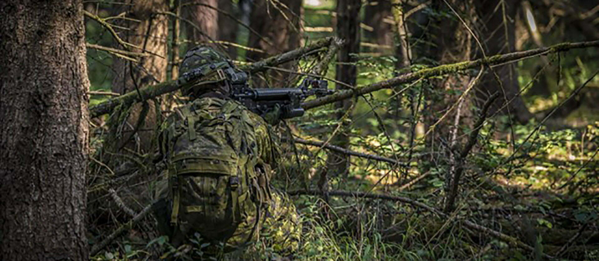 A hunter is camouflaged in a strategic location performing his important role.